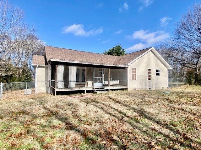 rear view of property with a sunroom and a yard