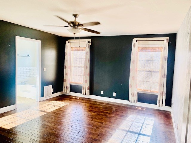 empty room with hardwood / wood-style flooring and ceiling fan