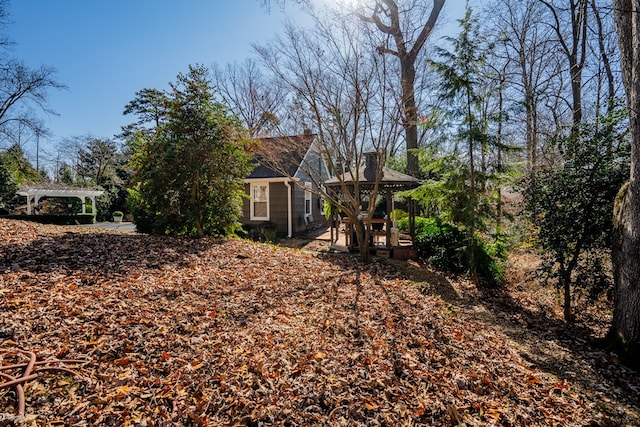 view of yard featuring a gazebo and a pergola