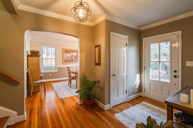 entryway with crown molding and wood-type flooring