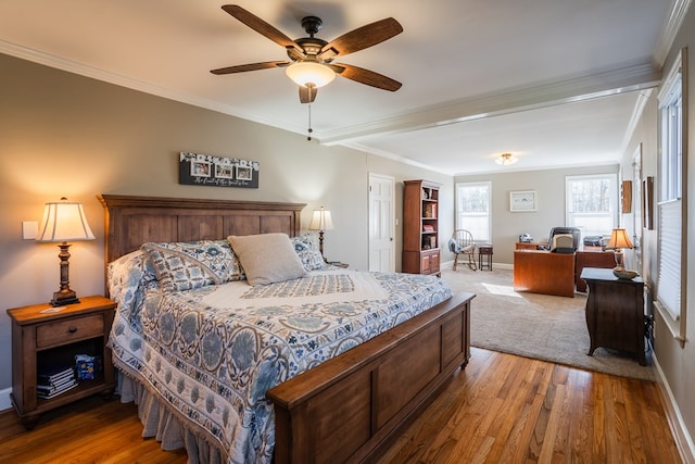 bedroom with crown molding, ceiling fan, and wood-type flooring