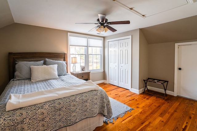 bedroom featuring ceiling fan, lofted ceiling, wood-type flooring, and a closet