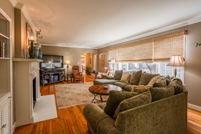 816 Dogwood Ln, Dalton, GA 30720 - living area with a fireplace with flush hearth, wood finished floors, crown molding, baseboards, and built in shelves