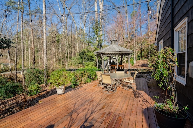 wooden terrace featuring a gazebo