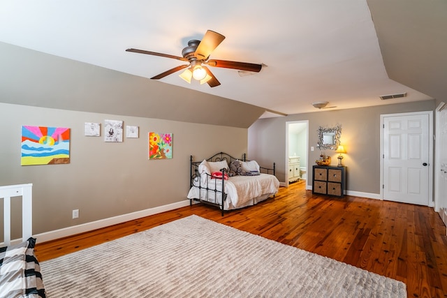 bedroom featuring hardwood / wood-style flooring, ceiling fan, lofted ceiling, and ensuite bath