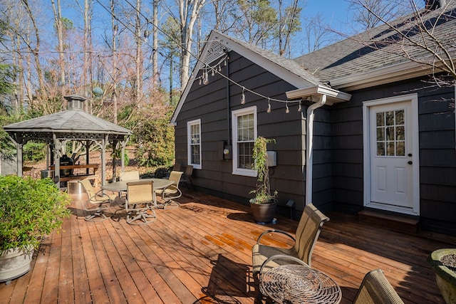 wooden terrace featuring a gazebo