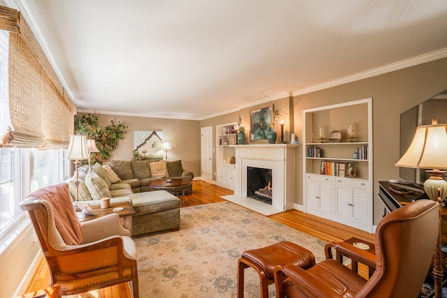 living room with ornamental molding, wood-type flooring, and built in features