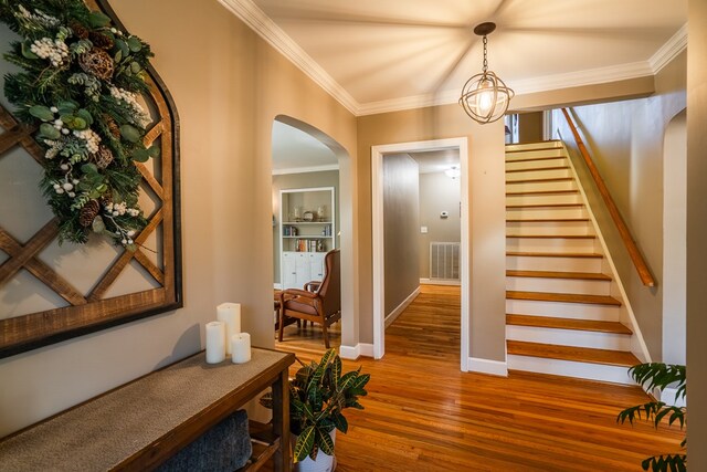 816 Dogwood Ln, Dalton, GA 30720 - foyer featuring arched walkways, wood finished floors, crown molding, stairs, and baseboards