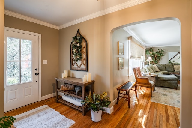 foyer with hardwood / wood-style flooring and ornamental molding