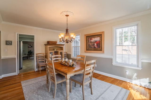 816 Dogwood Ln, Dalton, GA 30720 - dining area with a chandelier, ornamental molding, wood finished floors, and baseboards
