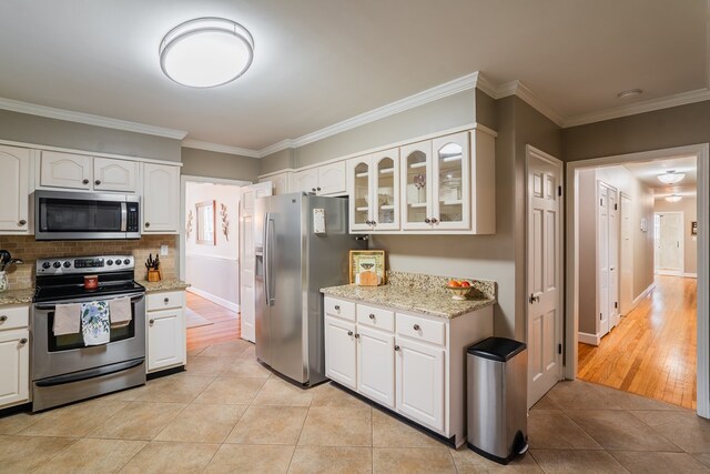 816 Dogwood Ln, Dalton, GA 30720 - kitchen featuring stainless steel appliances, white cabinetry, light tile patterned flooring, glass insert cabinets, and ornamental molding