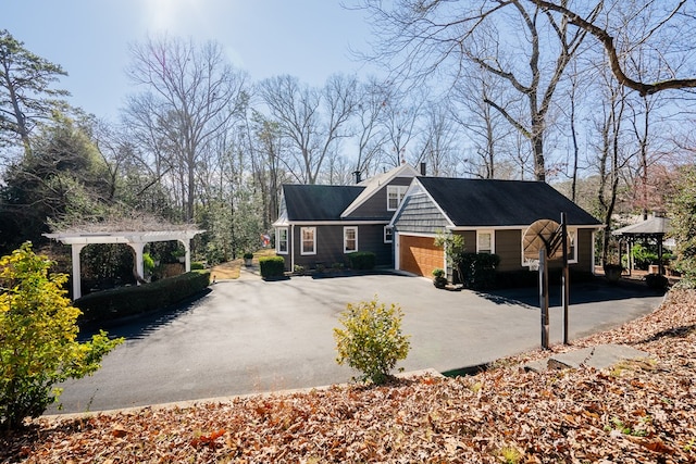 view of side of property with a garage and a pergola