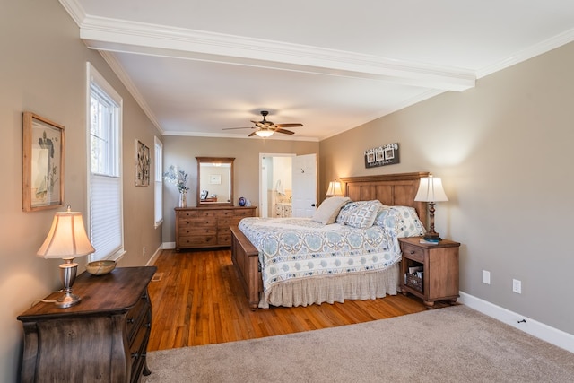 bedroom with hardwood / wood-style flooring, ornamental molding, ensuite bathroom, and ceiling fan