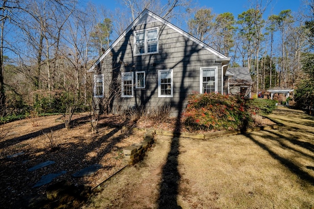 view of property exterior with a yard