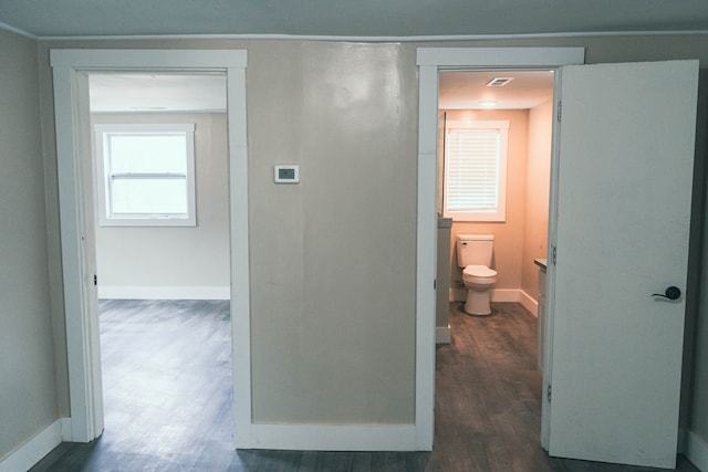 bathroom featuring baseboards, toilet, and wood finished floors