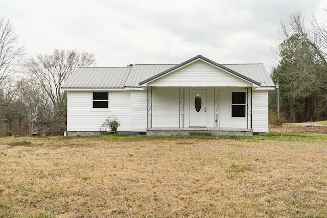 single story home featuring metal roof, a porch, and a front yard