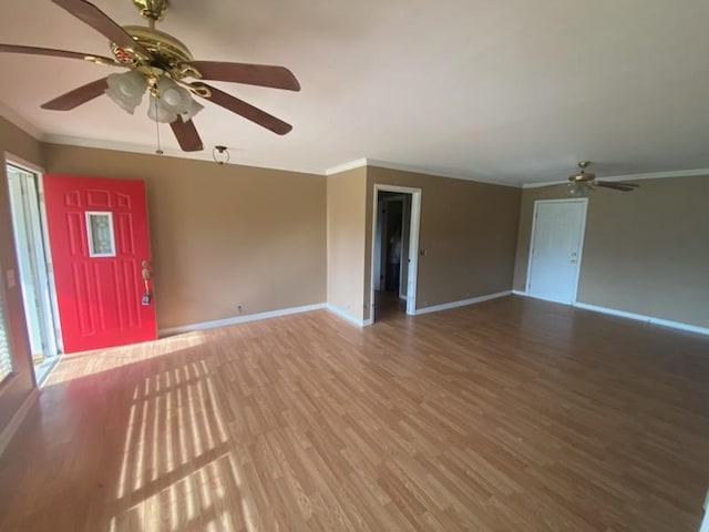 unfurnished living room featuring hardwood / wood-style flooring, ceiling fan, and ornamental molding