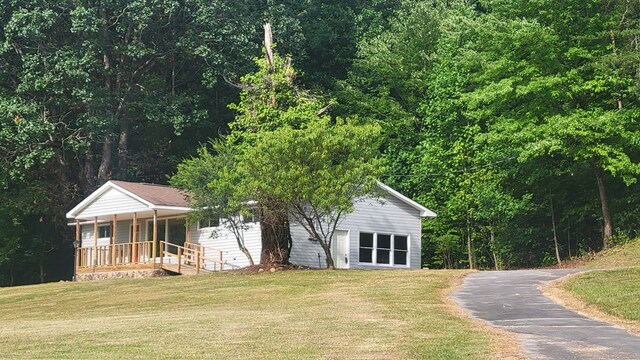 2517 Utility Rd, Rocky Face, GA 30740 - view of front facade with covered porch, a front yard, and driveway
