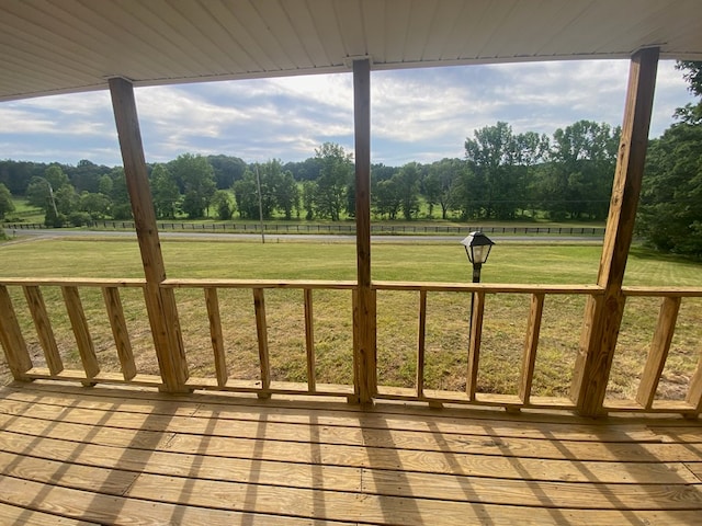 deck featuring a yard and a rural view