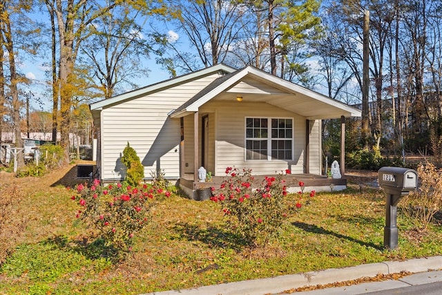 bungalow-style home featuring a porch and a front lawn