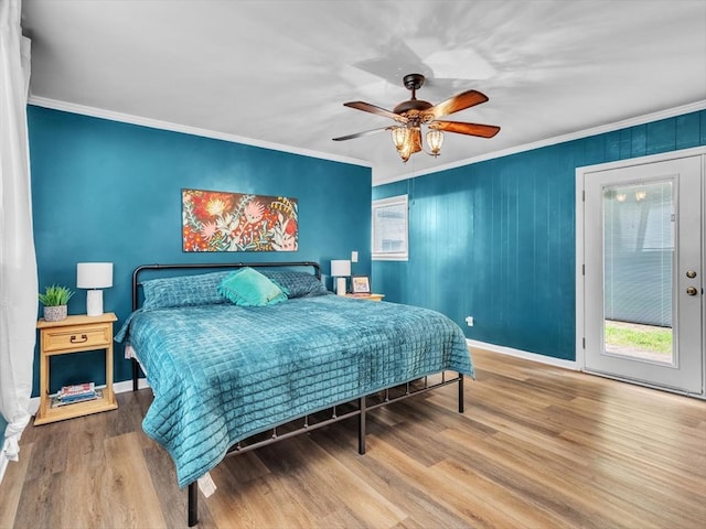 bedroom with wood finished floors, ornamental molding, baseboards, and a ceiling fan