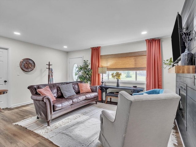 living area featuring wood finished floors, recessed lighting, and a fireplace