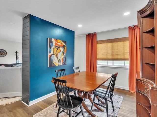 dining room with wood finished floors, baseboards, and recessed lighting