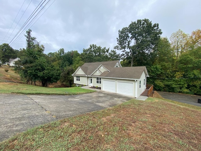 view of front of house featuring a garage and a front lawn