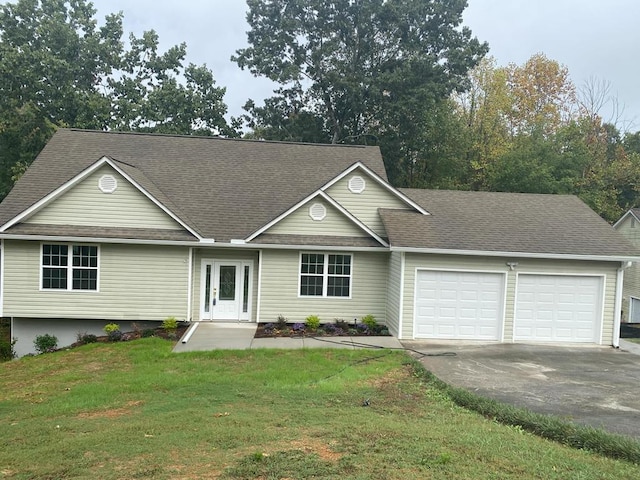 ranch-style house with a garage and a front yard