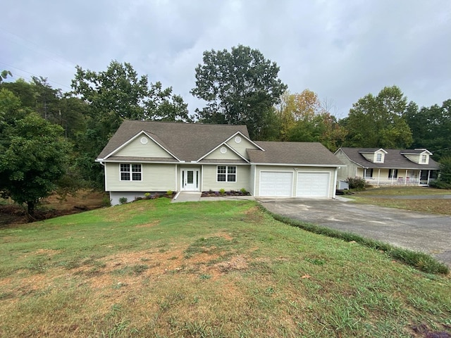 ranch-style house featuring a garage and a front lawn