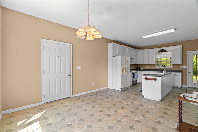 188 Valley Rd, Chatsworth, GA 30705 - kitchen featuring white appliances, a chandelier, white cabinetry, dark countertops, and decorative light fixtures