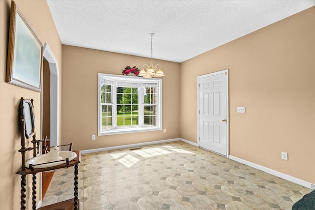188 Valley Rd, Chatsworth, GA 30705 - foyer entrance featuring a textured ceiling and a chandelier