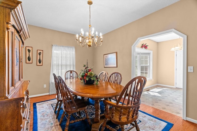188 Valley Rd, Chatsworth, GA 30705 - dining room featuring a chandelier, plenty of natural light, and light wood-type flooring