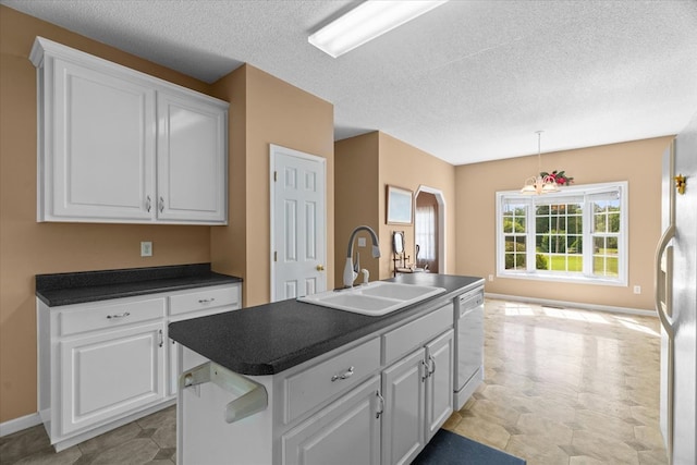 188 Valley Rd, Chatsworth, GA 30705 - kitchen featuring dishwasher, dark countertops, white cabinets, a kitchen island with sink, and a textured ceiling