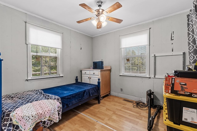 bedroom with ornamental molding, hardwood / wood-style floors, and ceiling fan