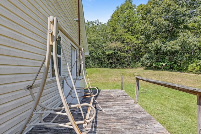 wooden terrace with a lawn