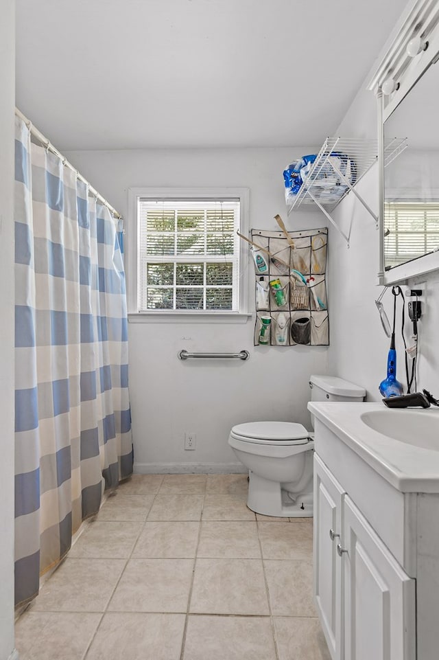 bathroom featuring vanity, toilet, and tile patterned flooring