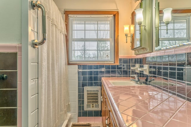 full bath featuring heating unit, a shower with curtain, tile walls, and vanity