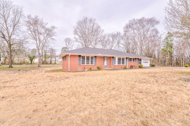 ranch-style house with a garage and brick siding