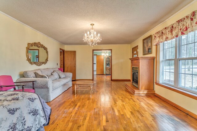 living area featuring light wood finished floors, crown molding, and a wealth of natural light