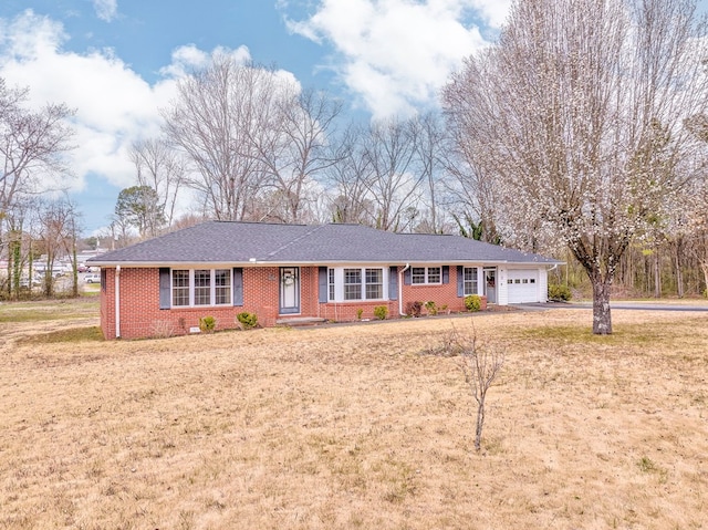 ranch-style house with brick siding, roof with shingles, and an attached garage