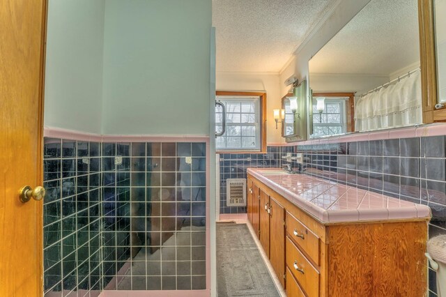 half bath with vanity, tile walls, and toilet