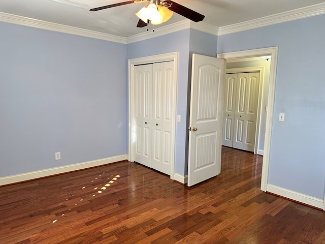 unfurnished bedroom with ornamental molding, dark hardwood / wood-style floors, ceiling fan, and a closet