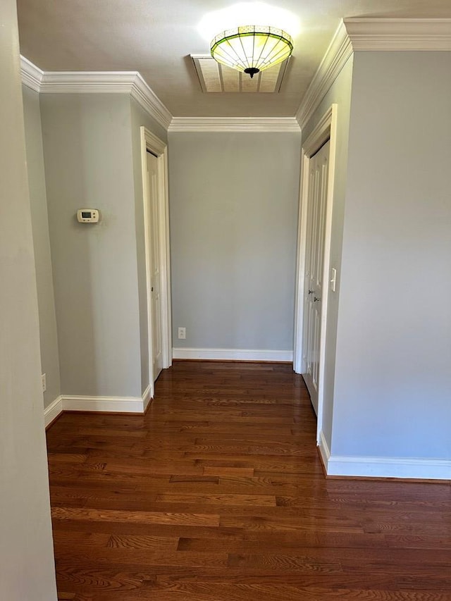 hallway with dark hardwood / wood-style flooring and crown molding