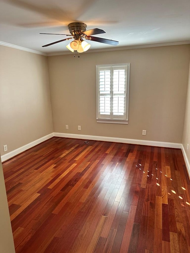 spare room featuring dark wood-type flooring, ceiling fan, and ornamental molding