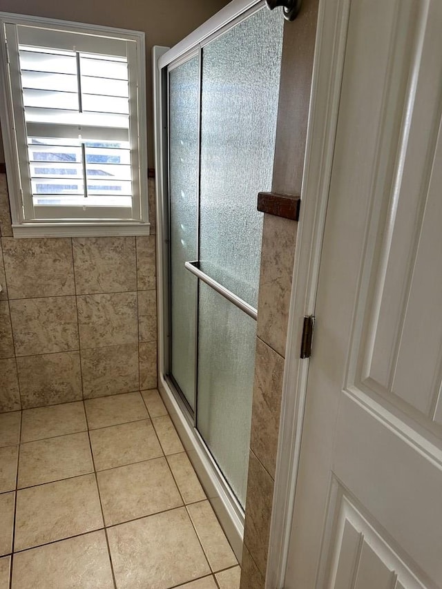 bathroom with tile patterned flooring and an enclosed shower