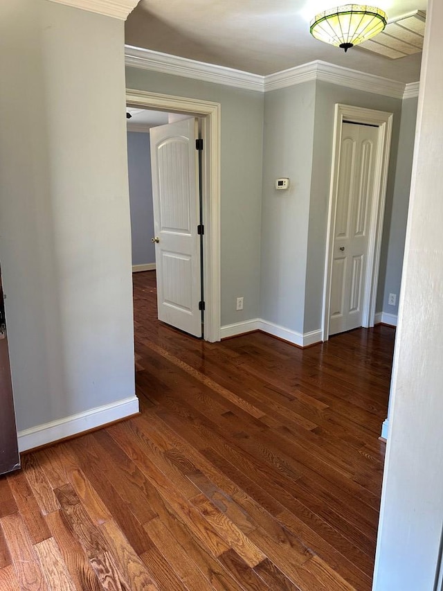 empty room with wood-type flooring and ornamental molding