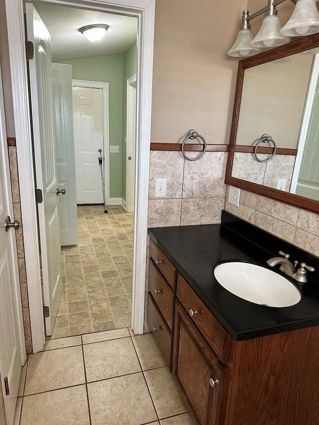 bathroom with vanity, decorative backsplash, and tile patterned floors