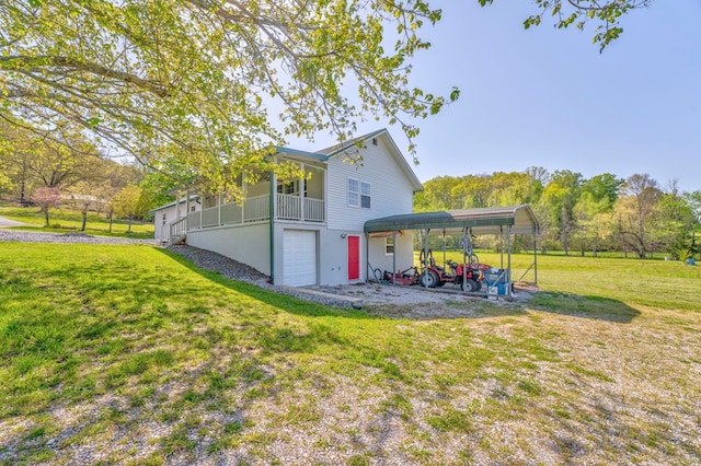 exterior space with stucco siding, an attached garage, and a yard