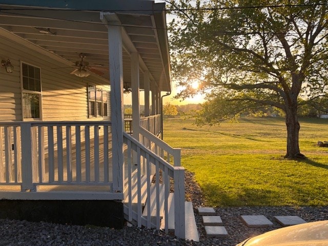 wooden terrace with a yard and ceiling fan